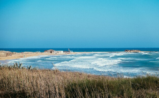 Scenic view of sea against clear blue sky