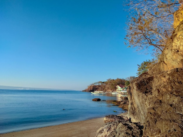 Scenic view of sea against clear blue sky