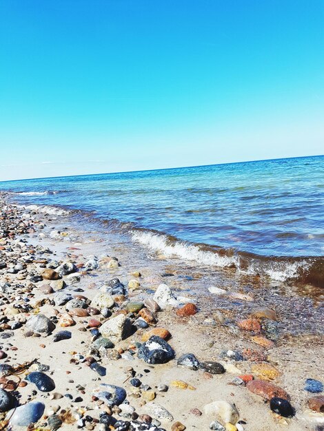 Scenic view of sea against clear blue sky