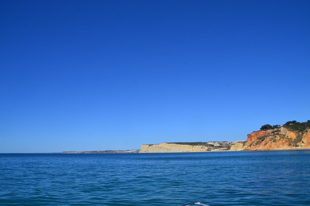 Scenic view of sea against clear blue sky