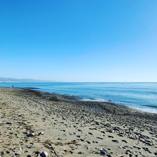 Scenic view of sea against clear blue sky