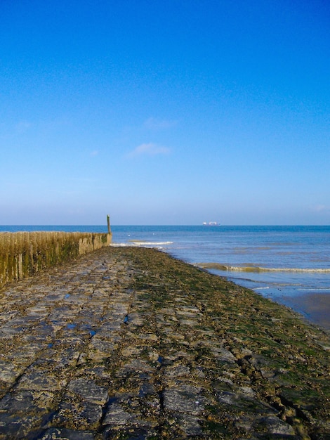 Scenic view of sea against clear blue sky