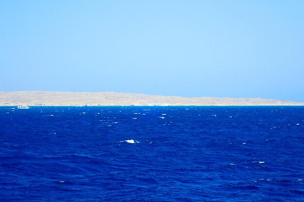 Scenic view of sea against clear blue sky