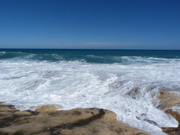 Scenic view of sea against clear blue sky