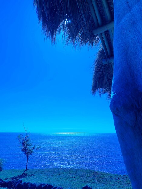 Scenic view of sea against clear blue sky