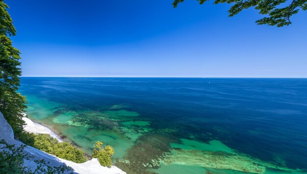 Scenic view of sea against clear blue sky