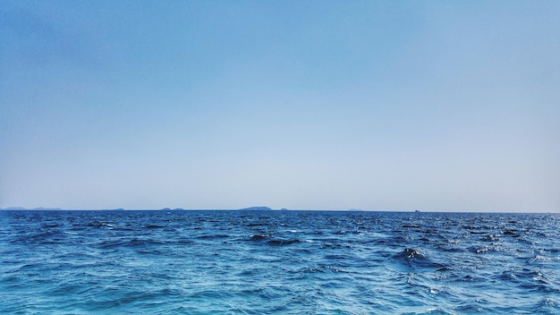 Scenic view of sea against clear blue sky