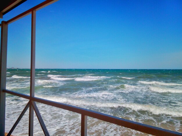 Scenic view of sea against clear blue sky