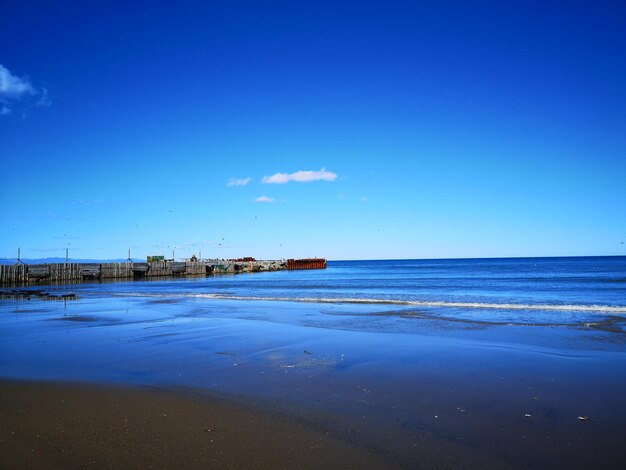 Scenic view of sea against clear blue sky