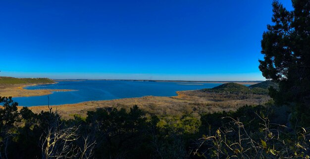 Scenic view of sea against clear blue sky