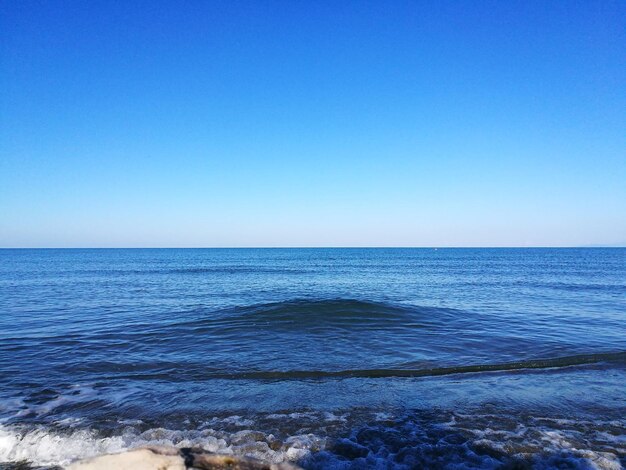 Scenic view of sea against clear blue sky