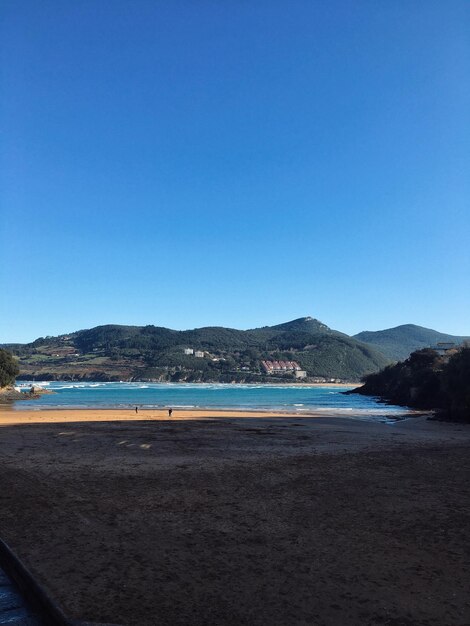 Scenic view of sea against clear blue sky