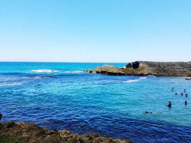 Scenic view of sea against clear blue sky