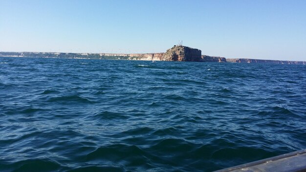 Scenic view of sea against clear blue sky