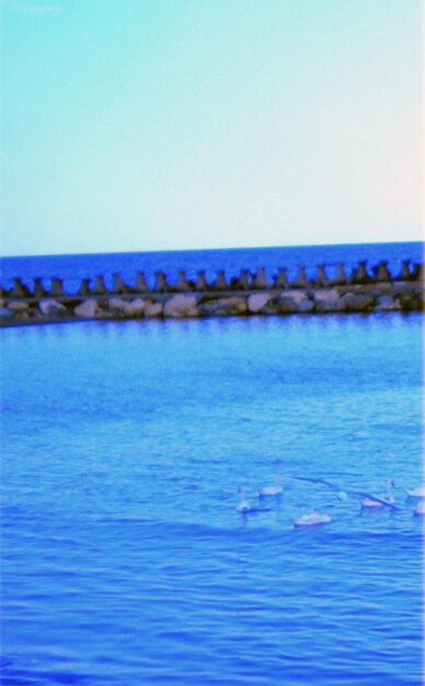 Scenic view of sea against clear blue sky