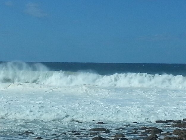 Scenic view of sea against clear blue sky