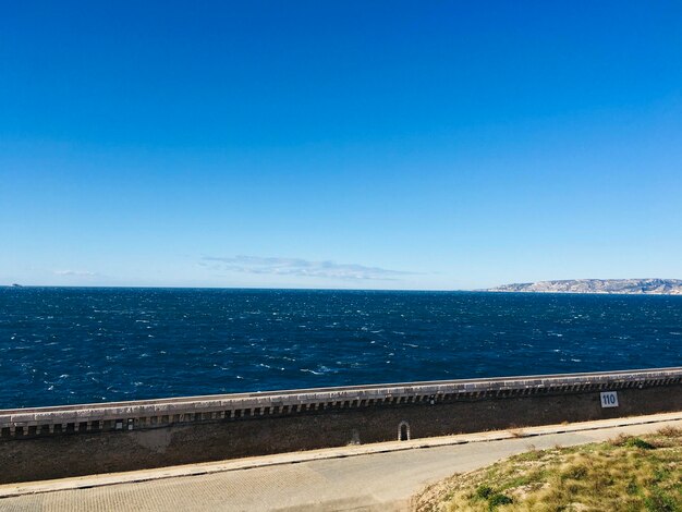 Scenic view of sea against clear blue sky