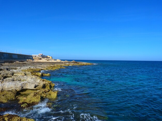 Scenic view of sea against clear blue sky