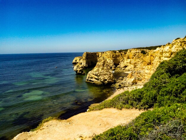 Scenic view of sea against clear blue sky