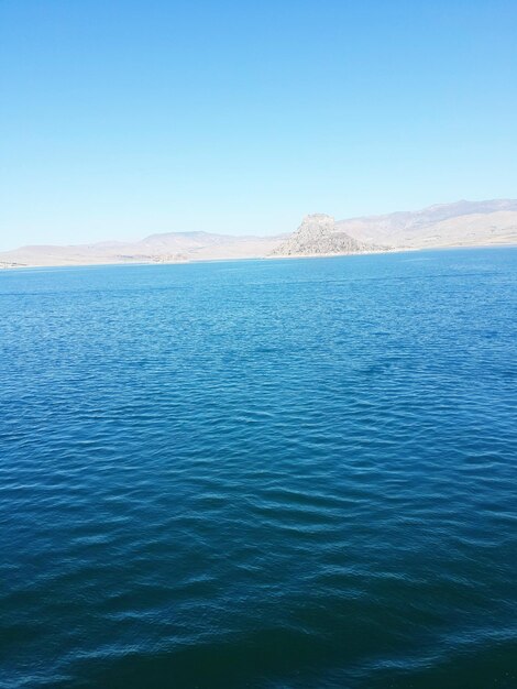 Scenic view of sea against clear blue sky