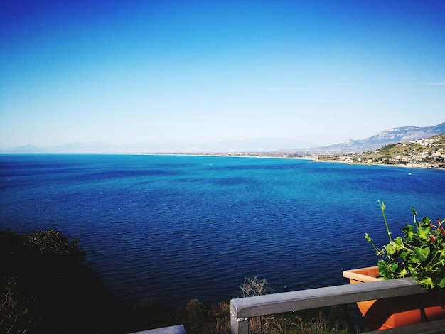 Scenic view of sea against clear blue sky