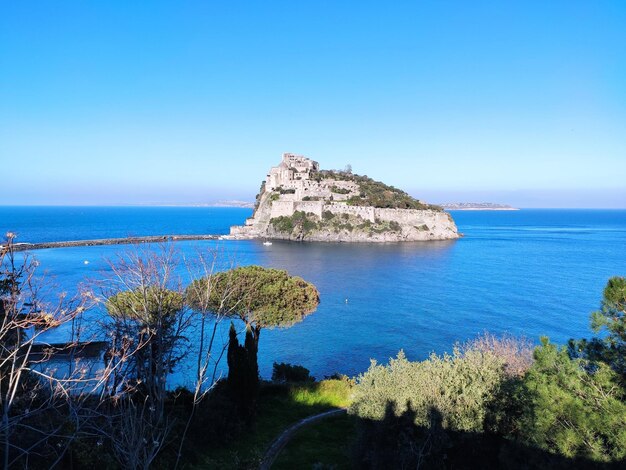 Scenic view of sea against clear blue sky