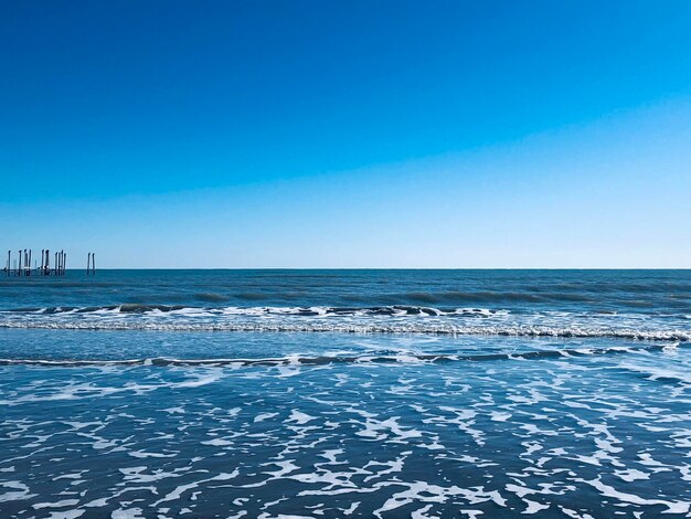 Scenic view of sea against clear blue sky