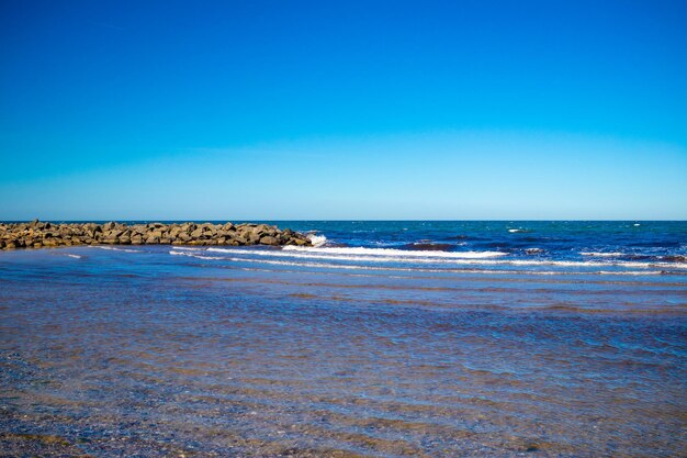 Scenic view of sea against clear blue sky