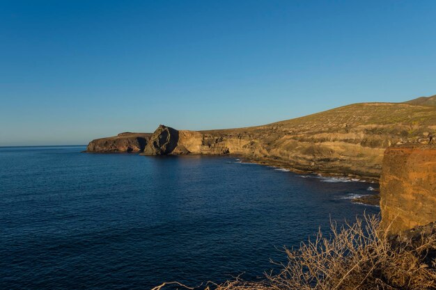 Scenic view of sea against clear blue sky