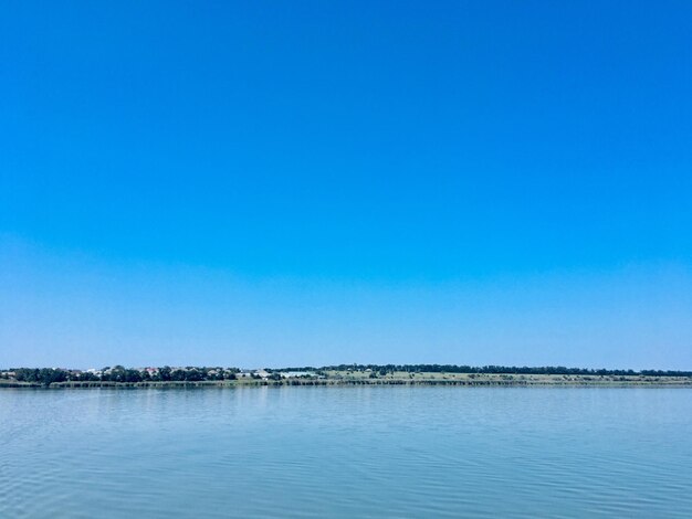 Scenic view of sea against clear blue sky