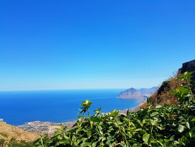 Scenic view of sea against clear blue sky