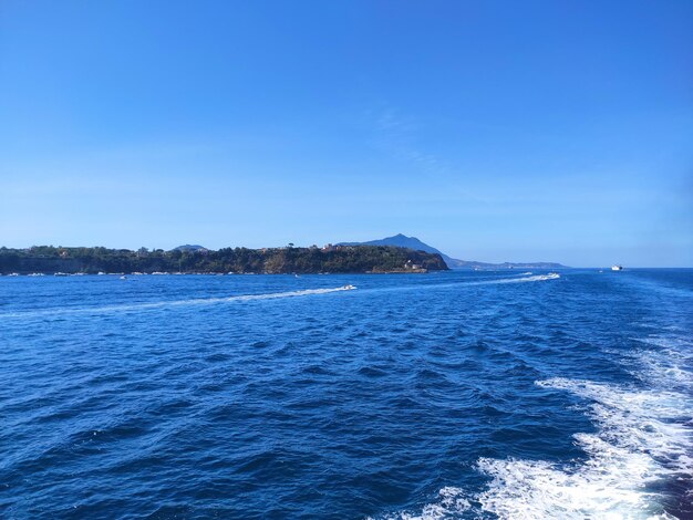 Scenic view of sea against clear blue sky