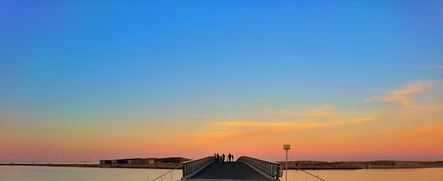 Scenic view of sea against clear sky during sunset