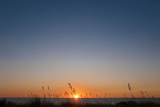 Scenic view of sea against clear sky during sunset