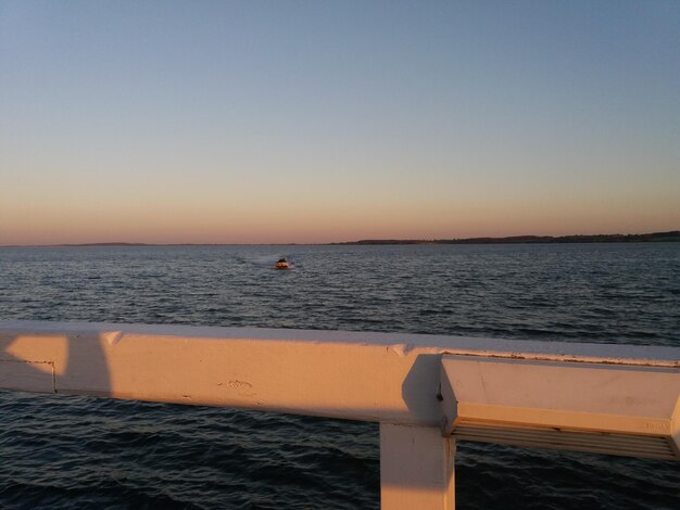 Scenic view of sea against clear sky during sunset