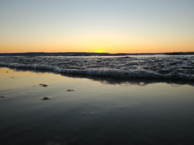 Scenic view of sea against clear sky during sunset