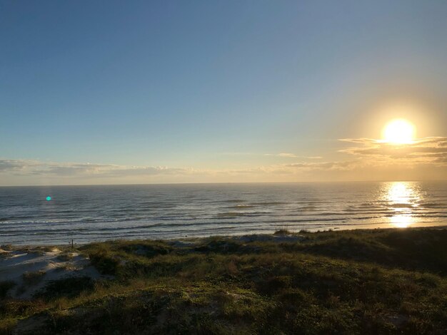 Scenic view of sea against clear sky during sunset