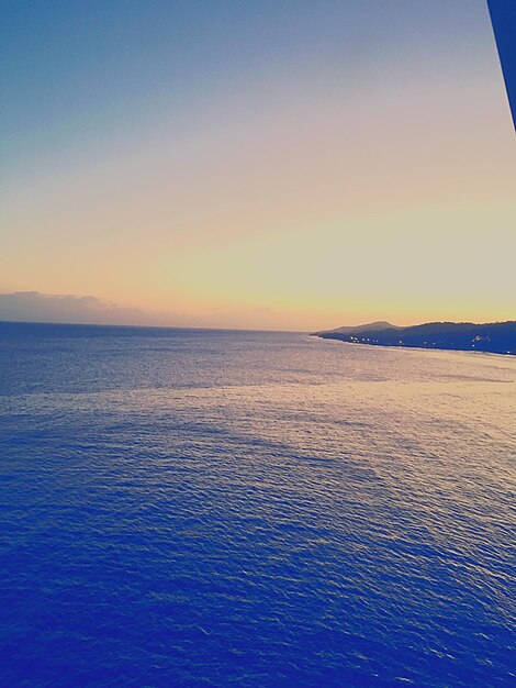 Scenic view of sea against clear sky during sunset