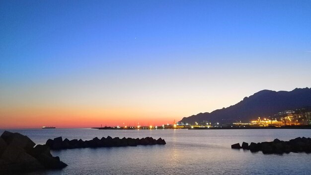 Scenic view of sea against clear sky during sunset