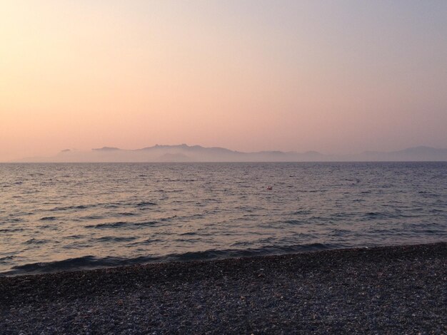 Scenic view of sea against clear sky at sunset