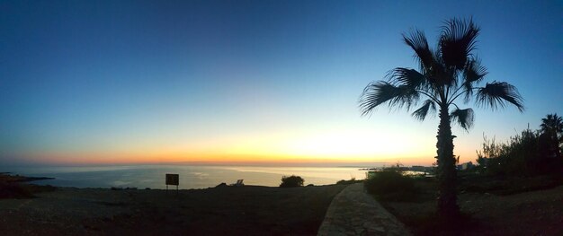 Scenic view of sea against clear sky at sunset