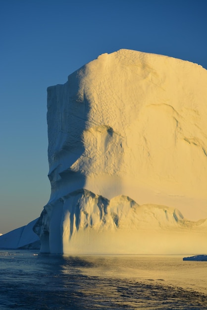 Scenic view of sea against clear sky with beautiful icebergs in the midnight sun ilulissat greenland