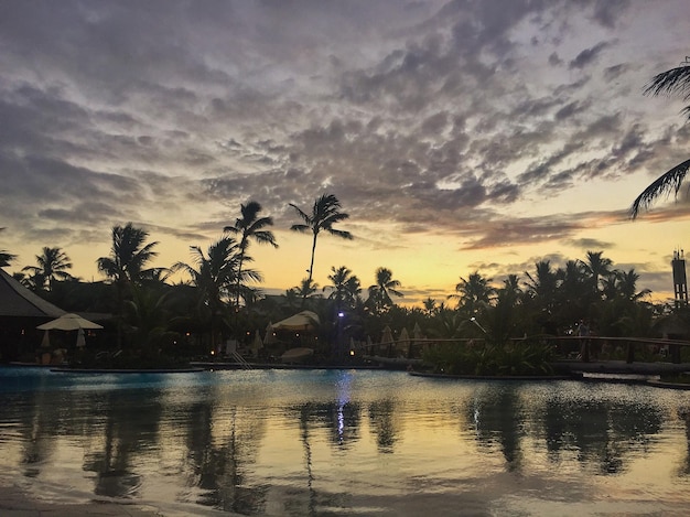 Scenic view of sea against cloudy sky at sunset