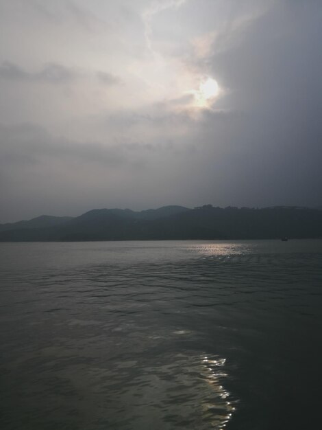 Scenic view of sea against cloudy sky