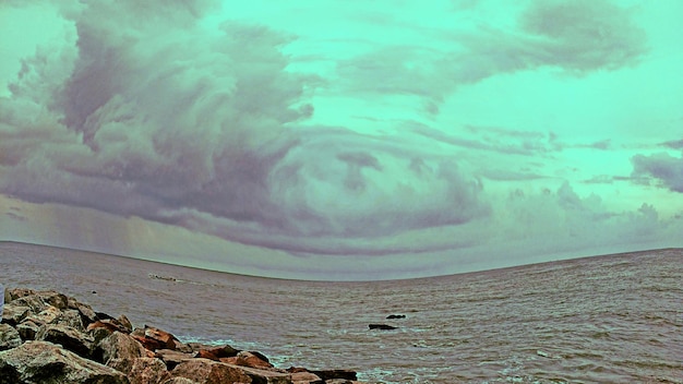 Scenic view of sea against cloudy sky