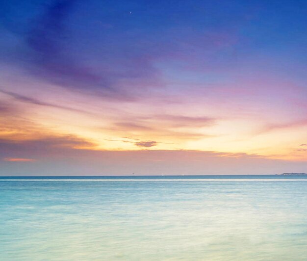 Scenic view of sea against dramatic sky during sunset