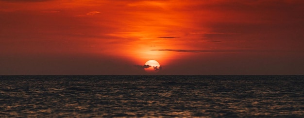 Scenic view of sea against dramatic sky during sunset