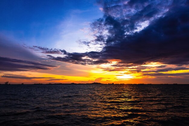 Scenic view of sea against dramatic sky during sunset