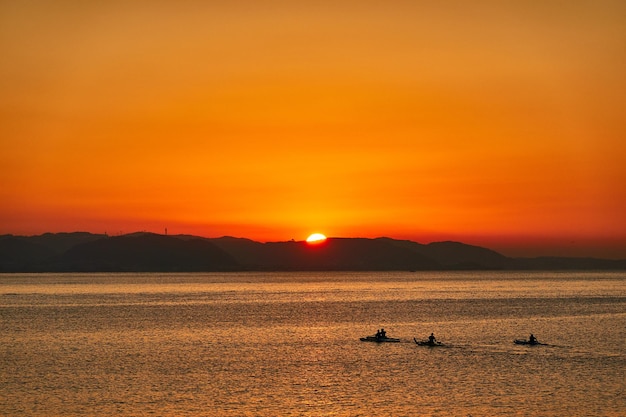 Scenic view of sea against orange sky during sunrise