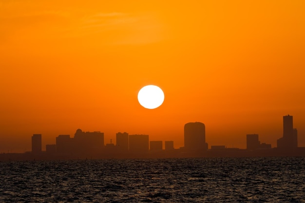 Scenic view of sea against orange sky during sunrise